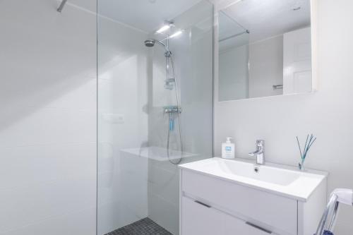 a white bathroom with a sink and a shower at Casa Viviana in Moraira
