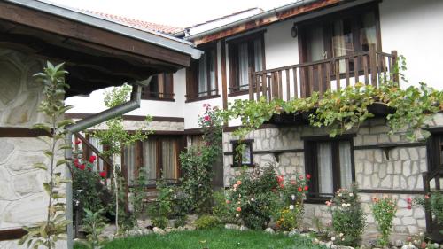 a house with flowers on the side of it at Trenchova Guest House in Bansko