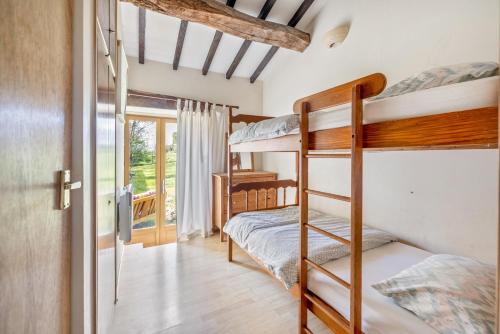 a bedroom with two bunk beds and a window at Gîtes Bourdeverre in Sanxay