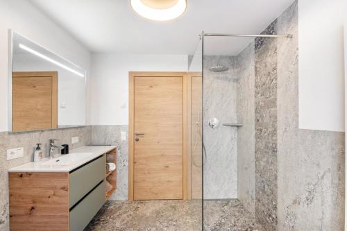 a bathroom with a shower and a sink at Pixnerhof - Ferienwohnung Golden in Kastelbell-Tschars
