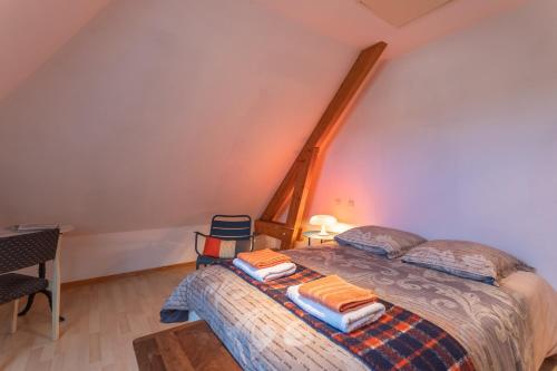 a bedroom with a bed with towels on it at Chambre d'hotes à Laroin in Laroin