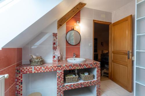a bathroom with a sink and a mirror at Chambre d'hotes à Laroin in Laroin