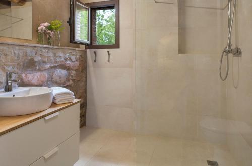 a bathroom with a sink and a shower at Can Bonet - la Volta in Sant Martí Vell