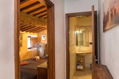 a door to a room with a bed and a mirror at Il Mirtillo in Pisa