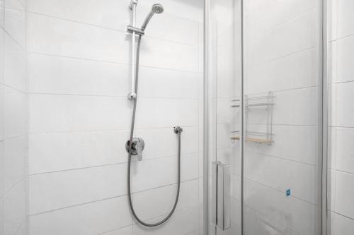 a shower in a bathroom with white tiles at Loft Guanapay 1 in Arona