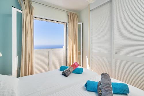 a bedroom with a bed with a large window at Stunning sea views pool garden in La Herradura