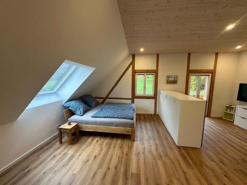 a room with a bed and a window in a house at Ferienwohnung Derday im Schuttertal in Schuttertal