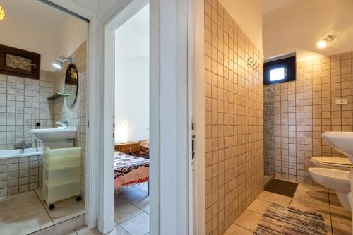 a bathroom with a sink and a toilet at Pergola 706 in Stintino