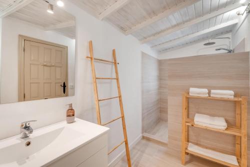 a bathroom with a white sink and a ladder at Casa Juliana Tijarafe in Tijarafe