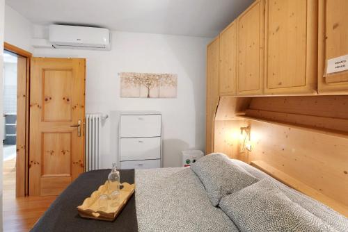 a bedroom with a bed and a wooden cabinet at Ciasa de Lucky in Moena