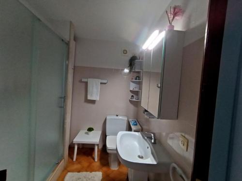 a bathroom with a sink and a toilet and a mirror at Villetta Son Bou in Son Bou