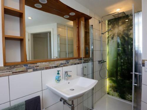 a bathroom with a sink and a mirror at Ferienwohnung Beim Falkner, 60qm in Königsfeld im Schwarzwald