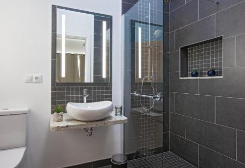 a bathroom with a sink and a shower at Villa Esencia in Puerto del Carmen