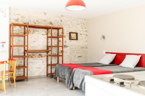 a small room with two beds and a kitchen at Studio L'Erdre au moulin - terrasse in Joué-sur-Erdre