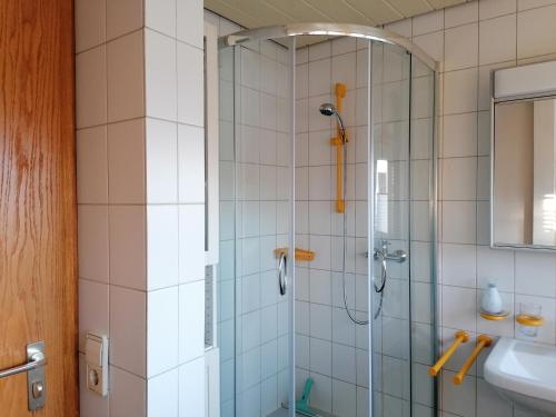 a bathroom with a glass shower with a sink at Ferienwohnung Kirsch-Kern in Mössingen