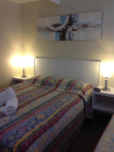 Postel nebo postele na pokoji v ubytování Motel Farnboro
