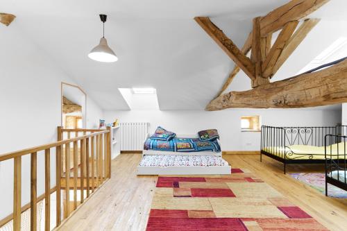 a living room with a couch and a staircase at Gite La Ferme En Sud Charente in Montboyer