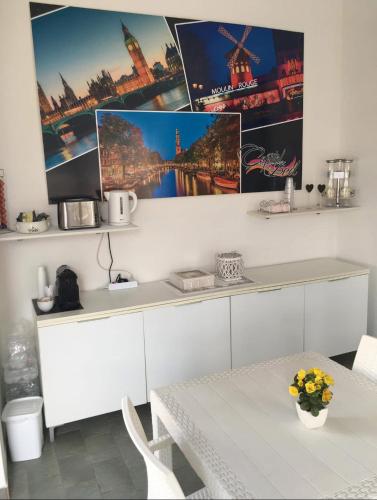 a kitchen with a white table and a table and a table and a table at Capital Bed Porto Cesareo in Porto Cesareo