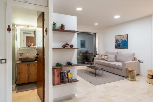 a living room with a couch and a table at The Apex Boutique Studio in Athens