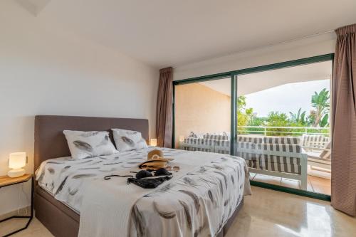 a bedroom with a bed with a hat and a window at Altea La Nova in Bernia