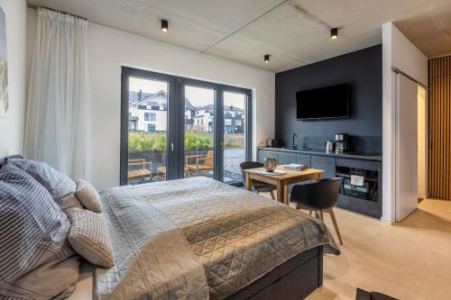 a bedroom with a bed and a table with a desk at Apartment Schlossterrassen 4a in Pouch