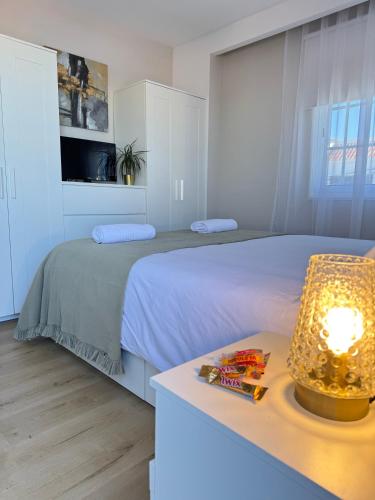 a bedroom with a bed and a table with a lamp at Chalet Mar Y Montaña in Los Silos