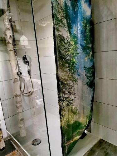 a shower in a bathroom with a shower curtain at Allgäu Fewo Hüttenflair Bergblick in Bad Hindelang