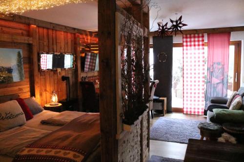 a bedroom with a bed in a room with wooden walls at Allgäu Fewo Hüttenflair Bergblick in Bad Hindelang