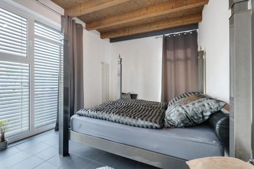 a bed in a room with a window at Deluxe Loft Hegau Bodensee in Hilzingen