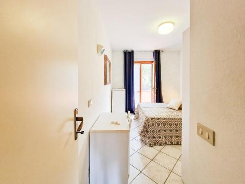 a room with a bedroom with a bed and a table at Altaluna Apartment with Pool in Nisporto