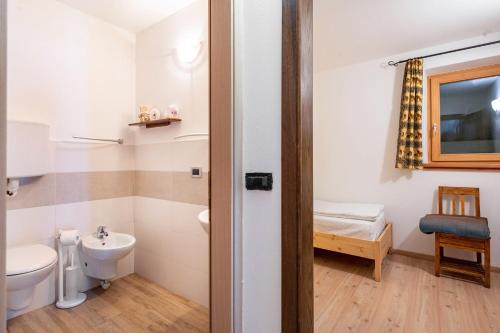 a bathroom with a toilet and a sink at Chalet Panorama Rabbi By Immobilux in Rabbi