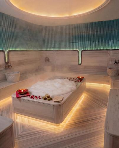 a bath tub in a room with a bed at Edition Old City Hotel in Istanbul