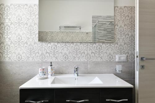 a bathroom with a sink and a mirror at Venere cala gonone vista mare in Cala Gonone
