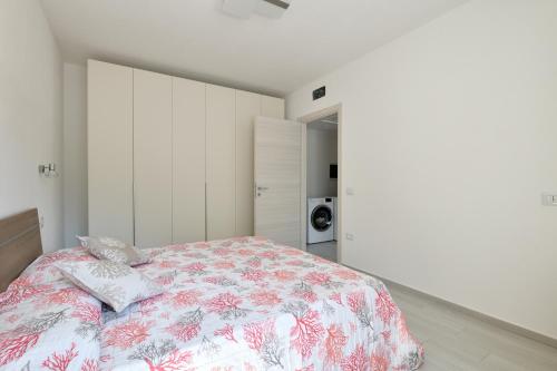 a bedroom with a bed with a floral bedspread at Venere cala gonone vista mare in Cala Gonone
