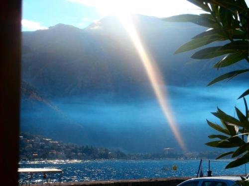 a view of a lake with a rainbow in the sky at Apartments Montenegro Risan Čučković in Risan