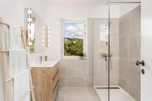 a bathroom with a shower and a sink at Petit Paradis Apartment in Son Bou