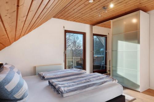 two beds in a room with a window at Ferienwohnung Steinhart in Lenzkirch