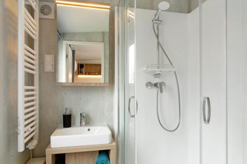 a bathroom with a sink and a shower at Tinyhouse Entspannung und Erholung in Untergriesbach
