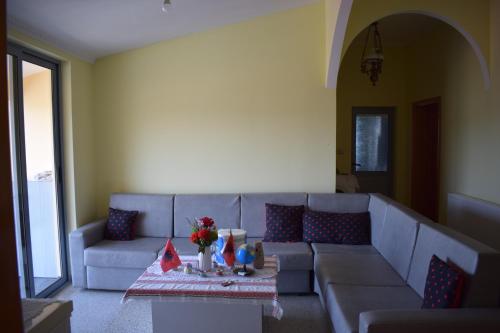 a living room with a couch and a table at Ulza Lake Escape in Ulëz