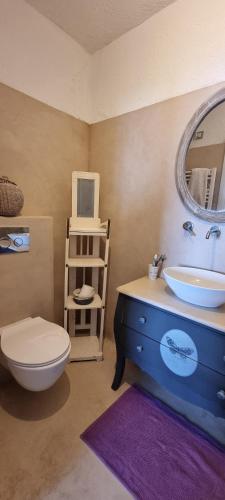 a bathroom with a sink and a toilet and a mirror at il Carrubo in Finale Ligure