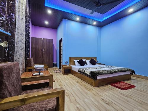 a bedroom with a bed and a blue light at Sangti River Front Homestay in Dirang Dzong