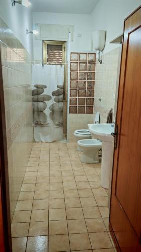 a bathroom with two toilets and a sink at Casa Vanda in Orte