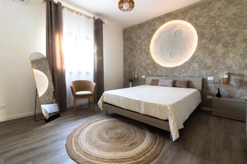a bedroom with a large bed and a rug at La Dimora di Luna in Terrasini