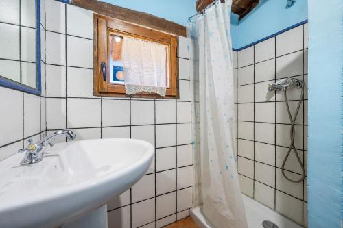 a bathroom with a sink and a shower at La Sala in Peñarroya de Tastavins
