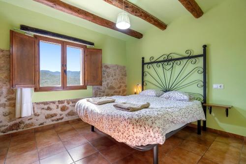 a bedroom with a bed and a window at La Sala in Peñarroya de Tastavins