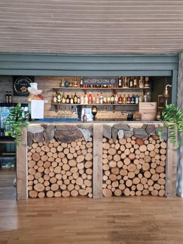 a store with a pile of logs on a counter at Lyngenfjord Hotel in Skibotn