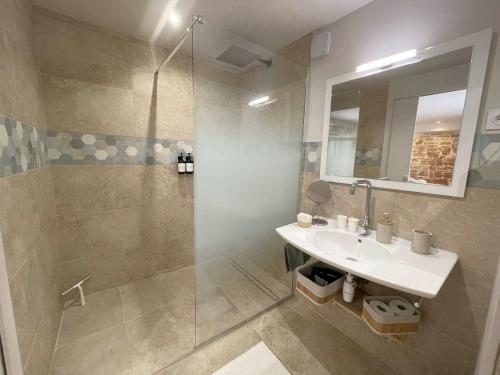 a bathroom with a sink and a shower at La Colombière in Salviac