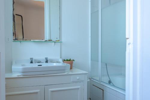 a white bathroom with a sink and a mirror at Belle villa basque in Anglet