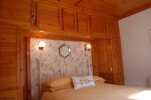 a bedroom with a bed with a wooden ceiling at Bryn Rhedyn Fairbourne in Fairbourne
