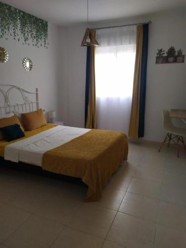 a bedroom with a large bed and a window at Cerca plaza de Toros Vera in Vera